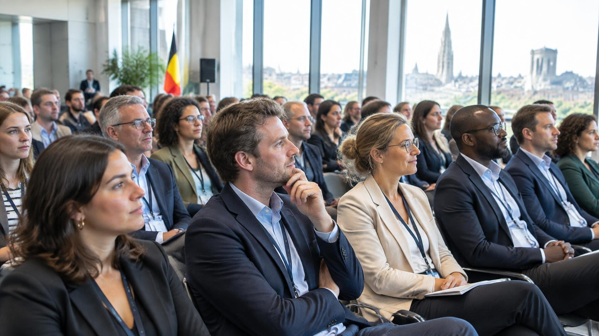 Audience seated in a conference hall listening to a speaker